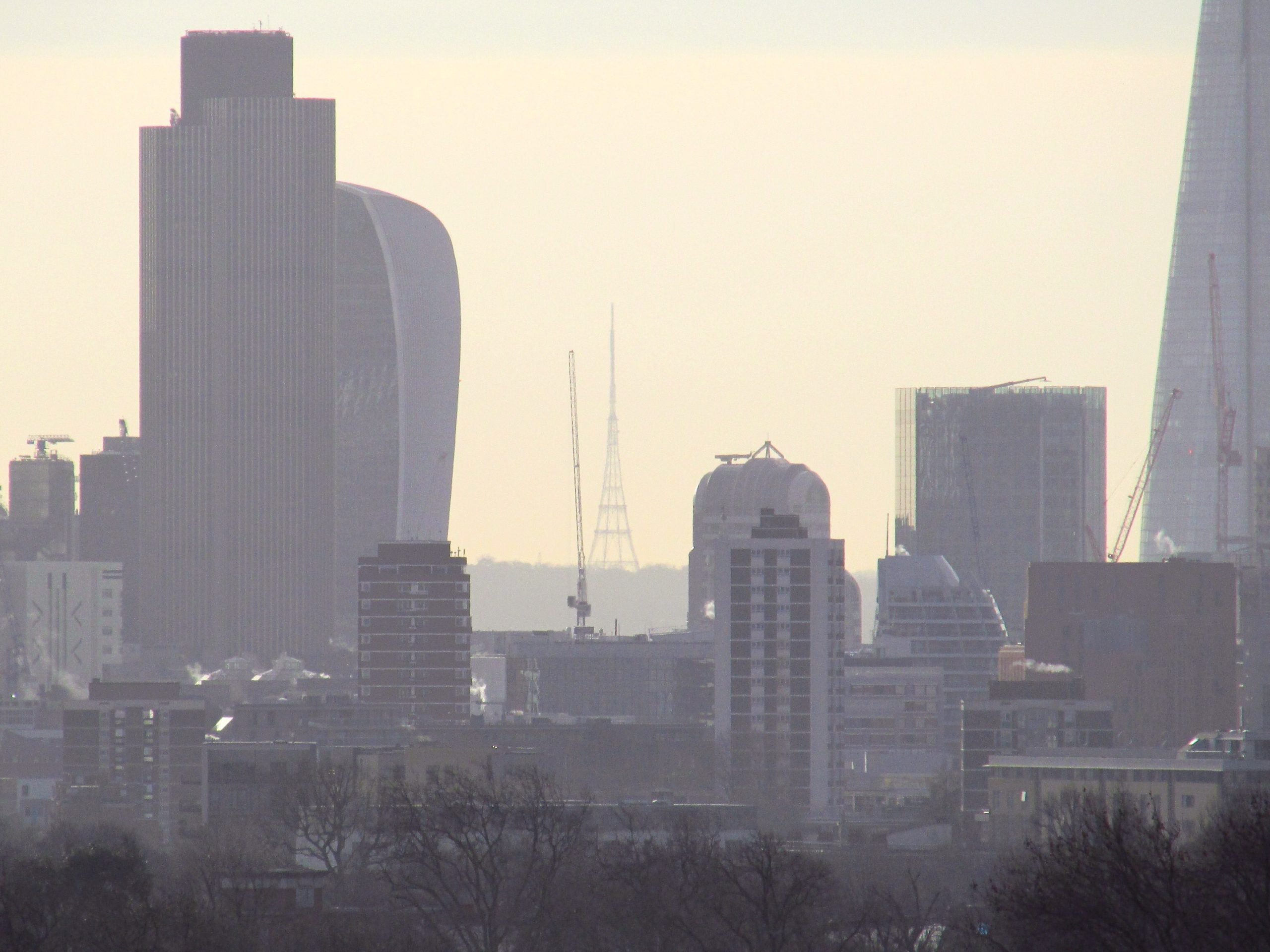 Air pollution sits over London, with several tall buildings silouhetted